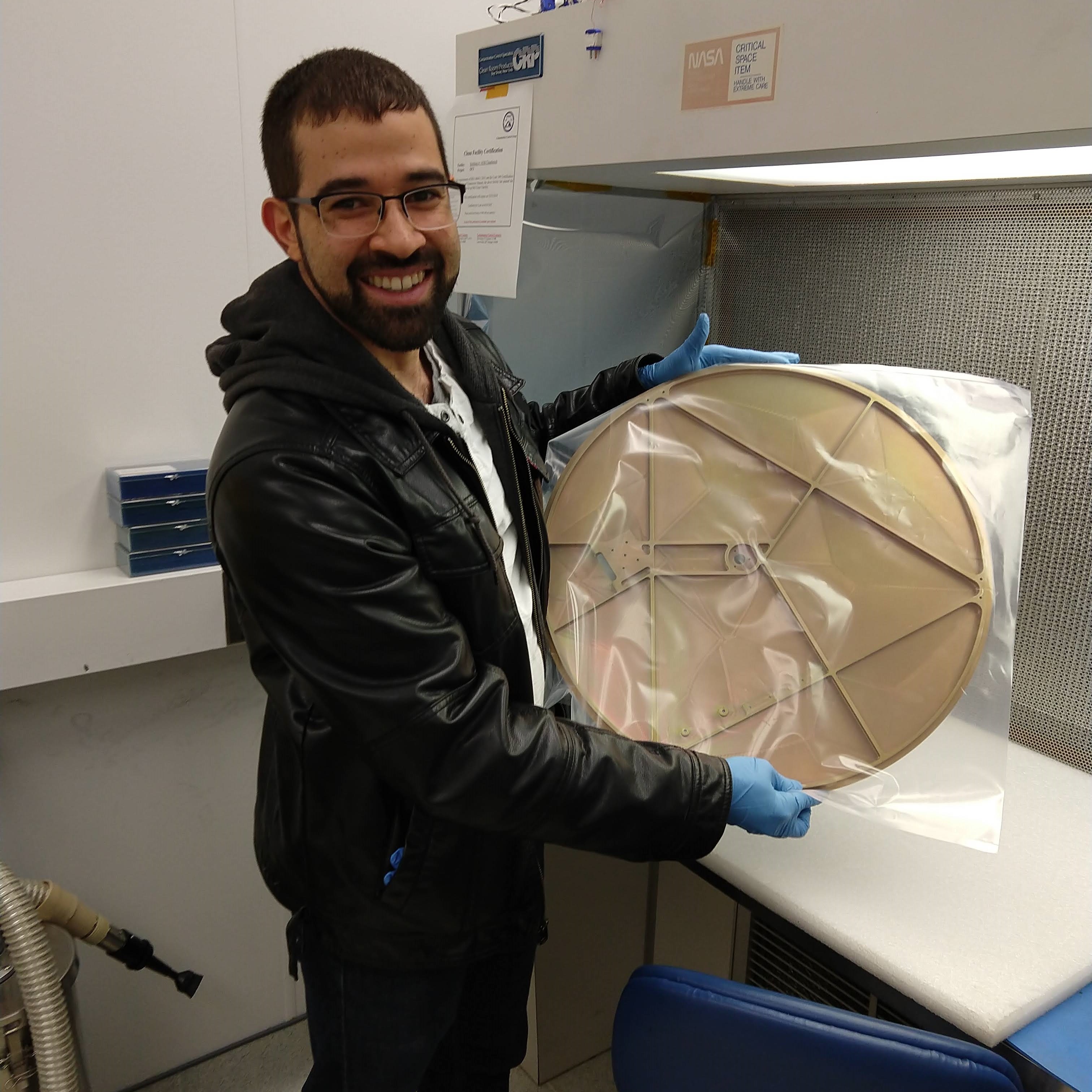 Juan Rodriguez from NASA GSFC of the L'Ralph team holds the coated LEISA flight radiator, which is used to cool down the LEISA detector down to -280 F.